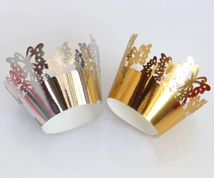 Laser-cut butterfly cupcake wrappers in gold and silver mirror finish for party decor