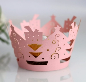 Macro shot of laser-cut pink Christmas tree patterns on a delicate cupcake wrapper