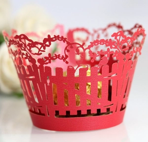 Laser-cut red wedding cupcake wrappers featuring hollow fence with flowers and birds