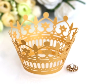 Close-up of golden crown laser-cut cupcake wrapper with elegant hollow-out pattern