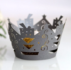 Laser-cut crown cupcake wrapper with intricate star patterns for festive decoration