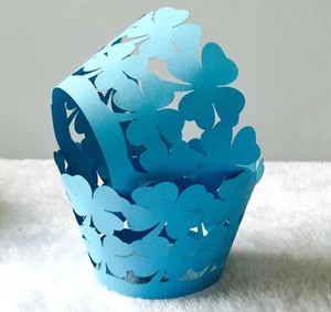 Sky blue laser cut cupcake wrappers with lucky clover pattern for party decoration