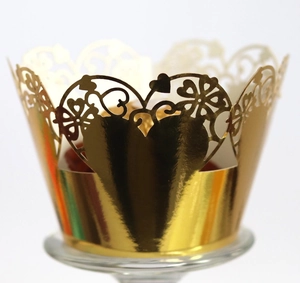 Golden laser-cut cupcake wrappers with heart floral patterns for wedding decorations