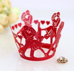 Laser-cut red cupcake wrapper with romantic kissing couple and heart silhouette details