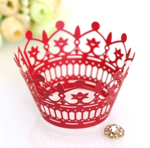Intricate laser-cut red crown cupcake wrapper with detailed hollow-out floral patterns
