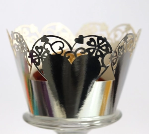 Close-up of laser-cut heart pattern on silver mirror cupcake wrappers for wedding decor