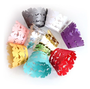 Laser-cut cupcake wrappers with clover flower patterns in assorted vibrant colors