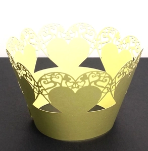 Detail of laser-cut heart pattern on olive green pearlescent paper cupcake wrappers