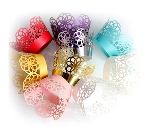 Laser-cut hollow cupcake wrappers with pearlescent floral pattern in various colors