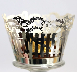 Silver laser cut cupcake wrapper featuring intricate vine and bird design for desserts