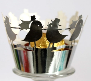 Silver laser-cut cupcake wrappers with romantic love birds for wedding party decor