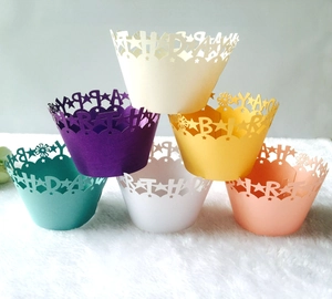 Colorful laser-cut Happy Birthday cupcake liners in multiple vibrant pastel paper colors