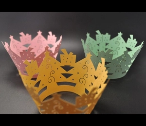 Three-color laser-cut Christmas cupcake wrappers with star patterns and gift box motifs