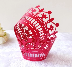 Detailed laser-cut hollow crown pattern on vibrant red paper cupcake wrapper decor