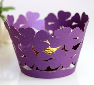 Purple laser-cut cupcake wrapper with clover design holding a gold foil chocolate