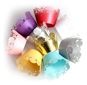 Detailed laser-cut sea shell cupcake wrappers in multiple metallic colors and patterns