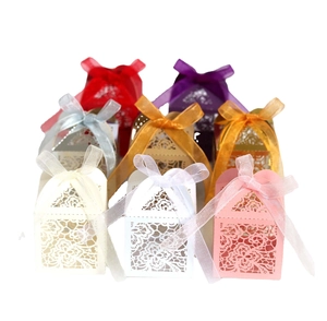 Laser cut lace wedding favor boxes with elegant floral patterns and organza ribbons