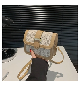 Close-up of beige woven straw crossbody bag with khaki leather trim and gold buckle