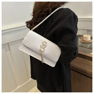Detail of white crocodile-embossed leather shoulder bag with gold logo and tassel