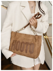 Brown velvet tote bag detail with HOOTO logo, gold chain strap and suede texture