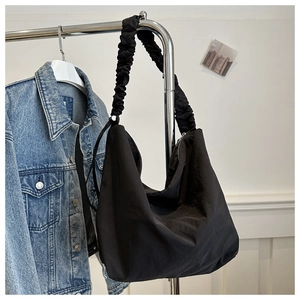 Close-up of lightweight black nylon hobo tote bag with a unique ruched cloud-style strap