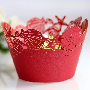 Red laser-cut cupcake liner with hollow sea shells and starfish marine patterns