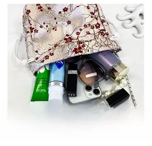 Detailed interior capacity showing large storage for phone and makeup accessories