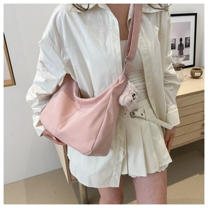 Pink minimalist hobo crossbody bag styled with a cute white plush puppy charm pendant