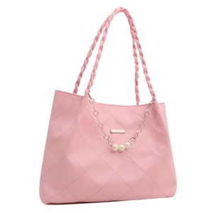 Pink quilted tote bag with woven handles and pearl chain accessory on a white background
