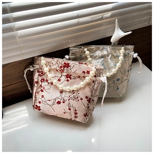 Detail of Jacquard drawstring bags with plum blossom patterns and pearl handles
