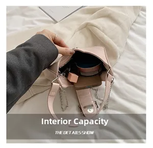 Detailed interior of pink bow shoulder bag showing storage space for phone and makeup