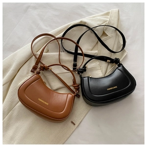 Detail of minimalist hobo bags in black and brown leather with knotted top handles