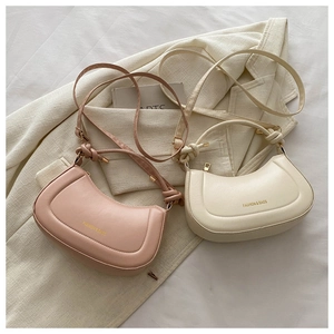 Detail of hobo bags with knotted shoulder straps and elegant matte PU leather texture