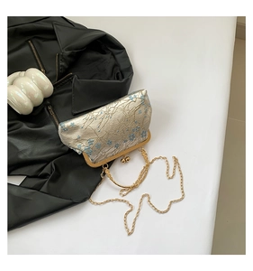 Detail of champagne gold floral embroidery on vintage metal frame crossbody bag