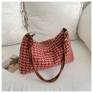 Detail of red and white plaid tweed shoulder bag with brown PU strap and knotted design