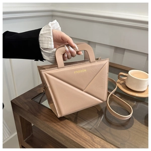 Detailed view of the beige pleated tote bag with a golden Fashion logo and handle