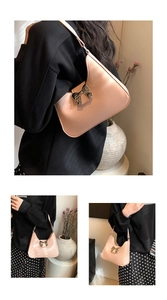 Detailed views of a pink crescent shoulder bag featuring a metallic bow and PU leather