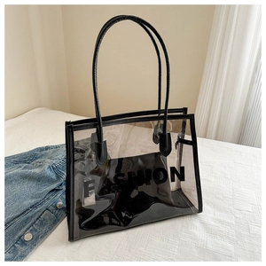 Macro shot of large transparent PVC tote bag with black trim and inner pouch details