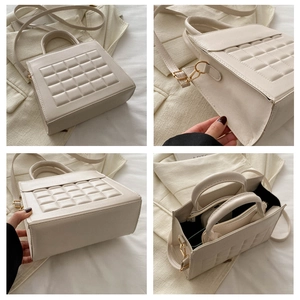 Dettaglio della borsa trapuntata beige che mostra la struttura e l'interno spazioso