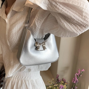Chic silver bow shoulder bag with chain strap and metallic finish for modern women