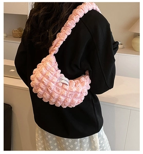 Detail of pink bubble texture shoulder bag with woven Love Fashion side label