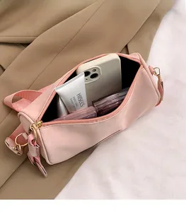 Pink cylinder shoulder bag showing large capacity for phone and cosmetics