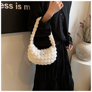 Detail shot of white bubble textured shoulder bag with soft pleated fabric finish