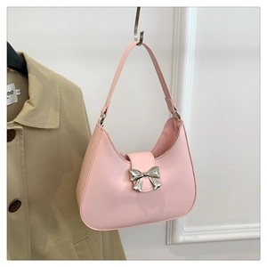 Detail of a pink crescent Hobo bag with a silver metallic bow buckle on smooth PU leather