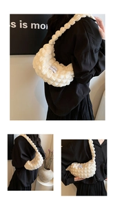 Detail of the white quilted cloud bag featuring bubble texture and Love Fashion woven label