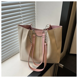 Detail view of large tote bag with cream white PU leather and pink chain strap