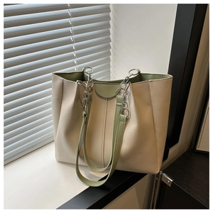 Detail showing high-quality leather texture and fashion lettering on stylish tote bag