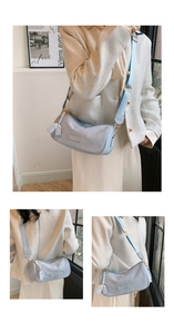 Detail of light blue cylinder crossbody bag with wide strap and gold hardware