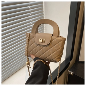 Detail of khaki quilted leather phone bag with golden ball chain and twist lock clasp