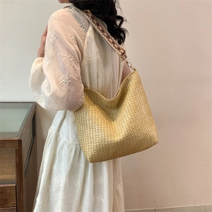 Large straw tote bag with geometric woven strap and natural fiber finish for summer